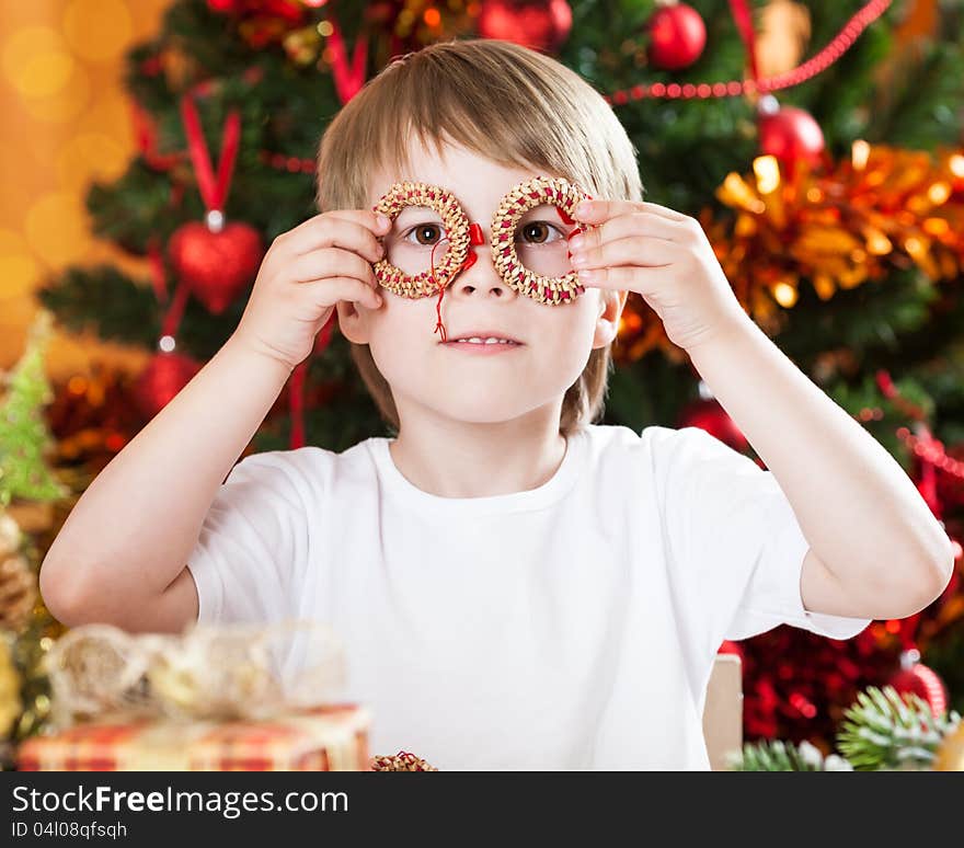 Smiling boy having fun against Christmas tree. Smiling boy having fun against Christmas tree