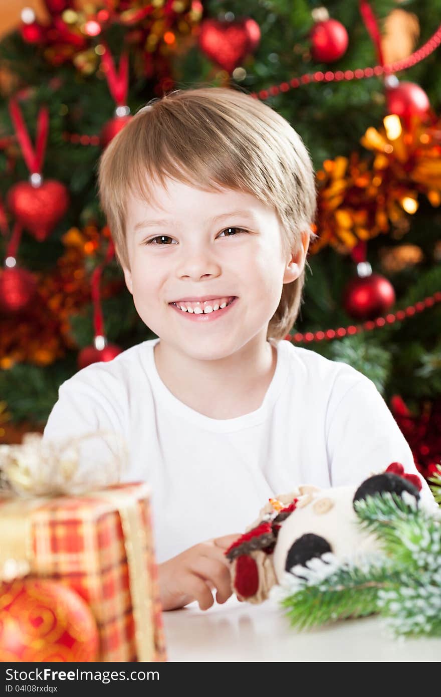 Happy smiling kid against decorated Christmas tree. Happy smiling kid against decorated Christmas tree