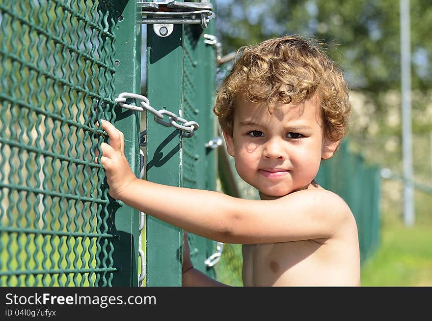 A boy who tries to sneak out through the gate. A boy who tries to sneak out through the gate.