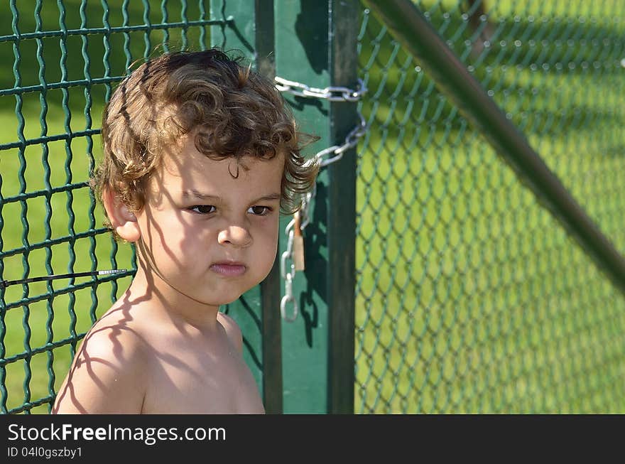 A boy who tries to sneak out through the gate. A boy who tries to sneak out through the gate.