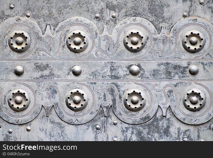 Ornaments on The iron door of an old gothic church. Ornaments on The iron door of an old gothic church.