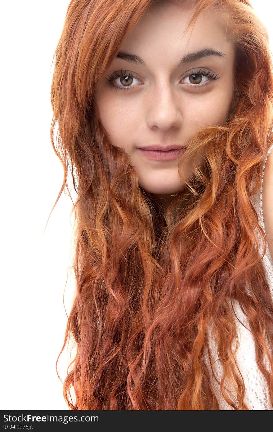 Portrait of a red haired girl of nineteen looking at the camera on white