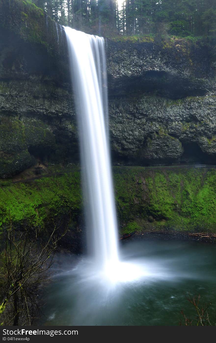 Natural beautiful waterfall in landscape. Panoramic view of the landscape with mossy rocks and pristine water. Natural beautiful waterfall in landscape. Panoramic view of the landscape with mossy rocks and pristine water.