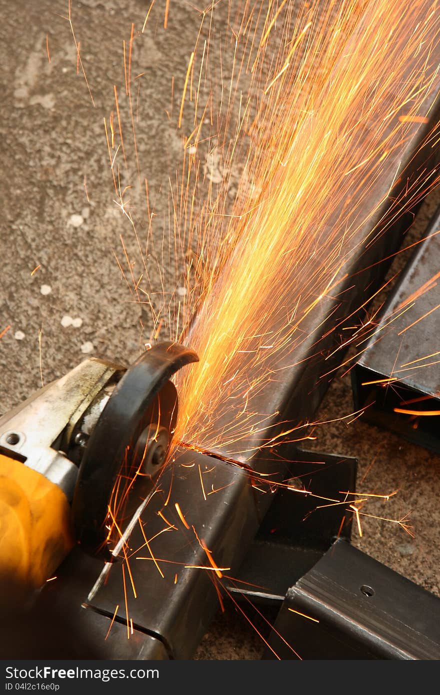 Cutting metal with sparkling gold. Cutting metal with sparkling gold.