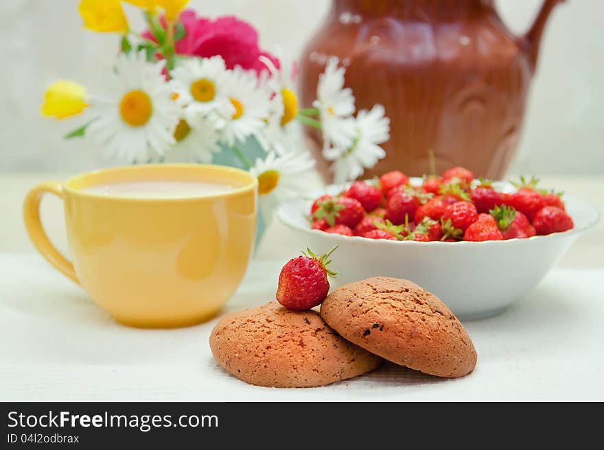 Still life with strawberries and cup of milk