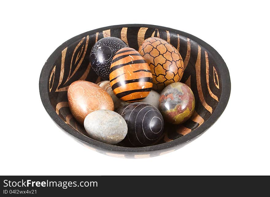 A nice wooden bowl with colorful eastereggs. Isolated on a white background. A nice wooden bowl with colorful eastereggs. Isolated on a white background.