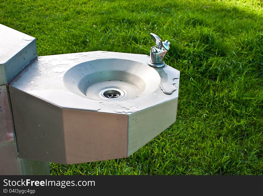 Drinks from a public drinking fountain