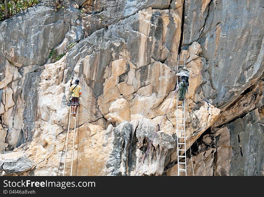 Workers made hole on the cliff for lamp installation.pranburi,thailand. Workers made hole on the cliff for lamp installation.pranburi,thailand