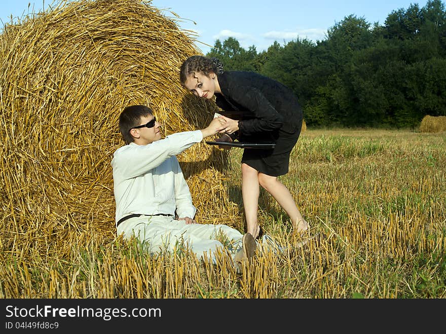 Boss and secretary near the haystacks. Boss and secretary near the haystacks