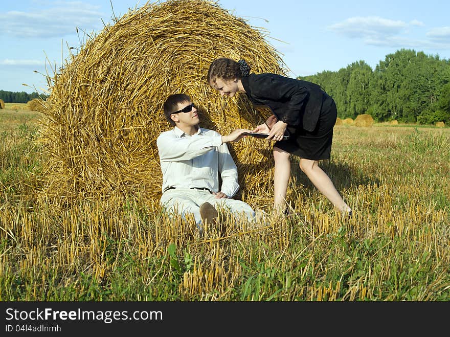 Colleagues are working with a laptop on the nature. Colleagues are working with a laptop on the nature