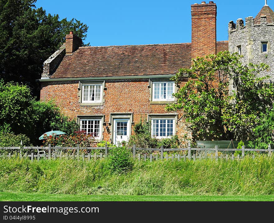 English red brick Rural House and garden with medievil tower. English red brick Rural House and garden with medievil tower