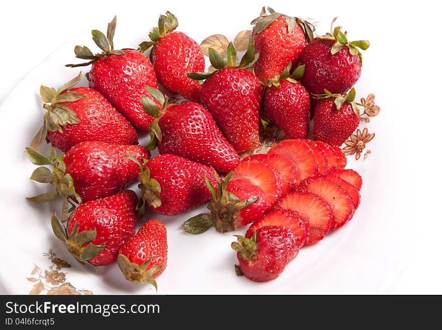 Strawberries in white dish on white background