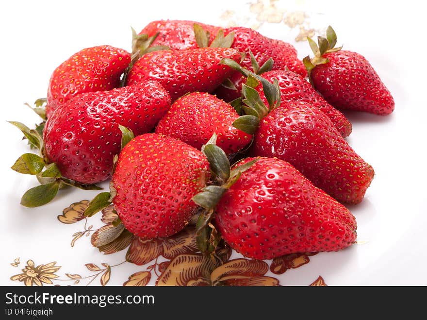 Strawberries in white dish on white background