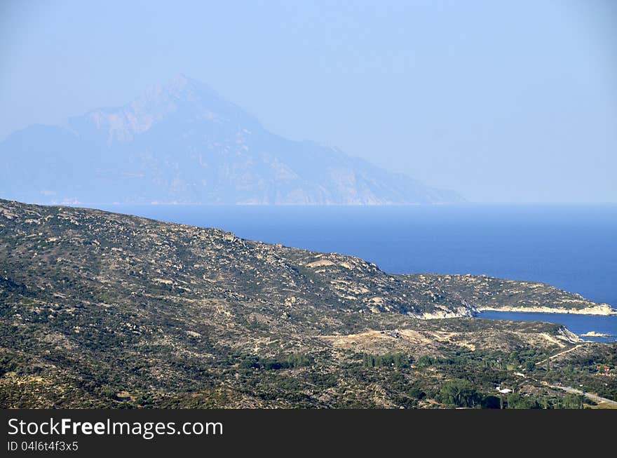 Golf beach in Sithonia peninsula of Halkidiki in Greece with view to Athos mountain. Golf beach in Sithonia peninsula of Halkidiki in Greece with view to Athos mountain