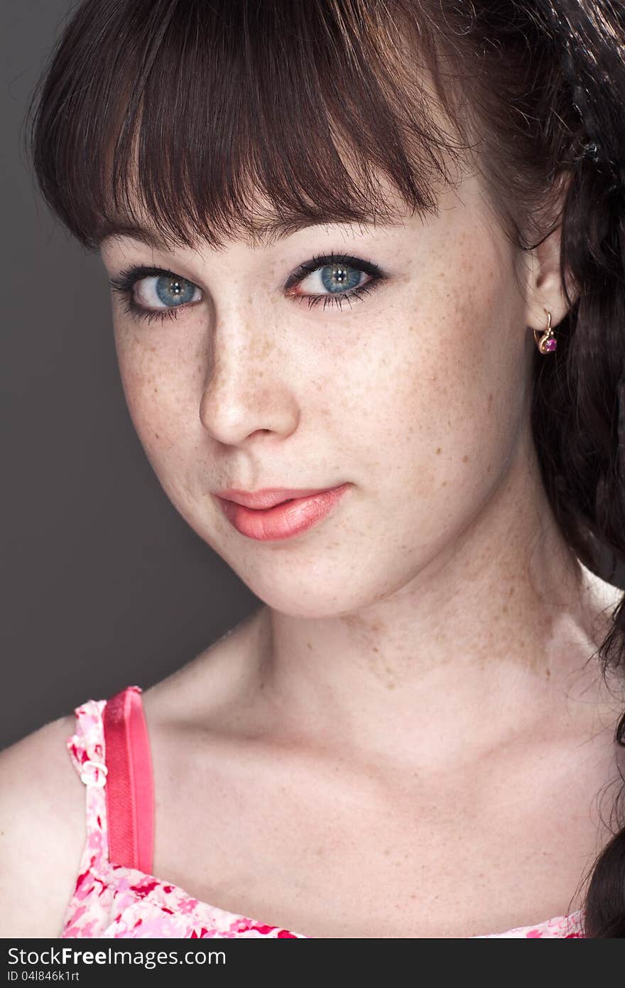 Close-up portrait of a beautiful girl with freckles. Close-up portrait of a beautiful girl with freckles