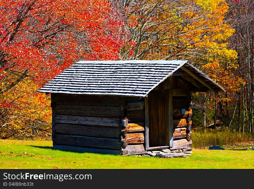 Log cabin or a hut in a autumn setting in the mountains