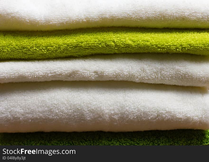 Pile of colourful white, green and lime towels. Pile of colourful white, green and lime towels