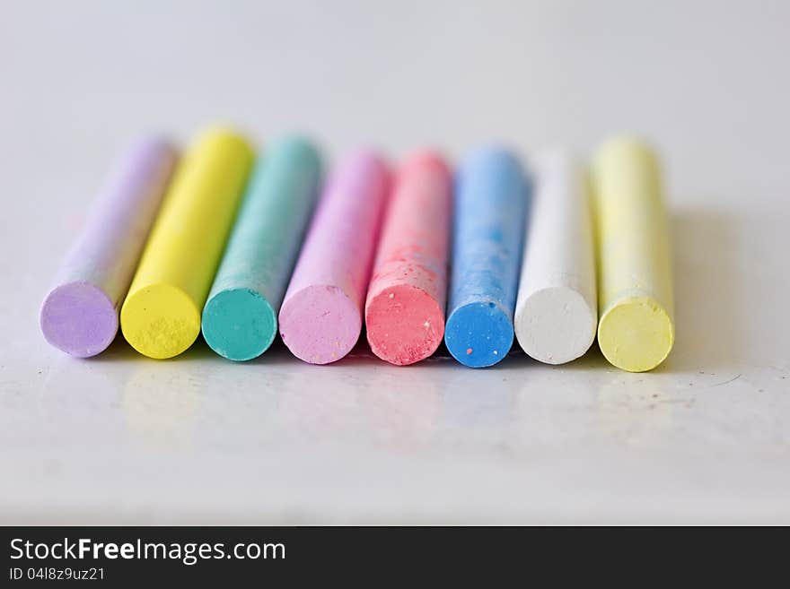 Colourful sticks of chalrs on metallic surface. Colourful sticks of chalrs on metallic surface