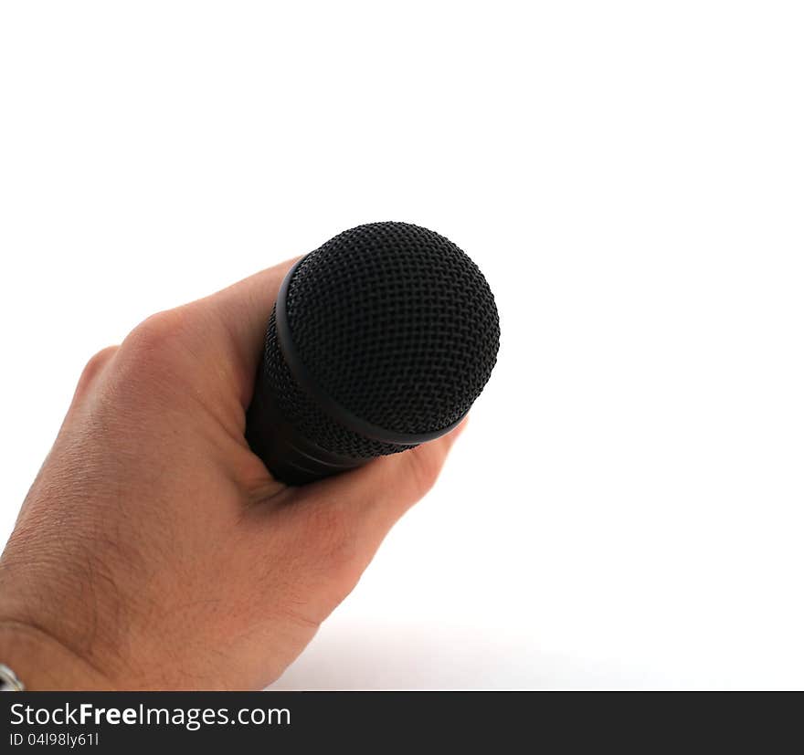 Hand with microphone over white, symbolic for public singing, speaking...