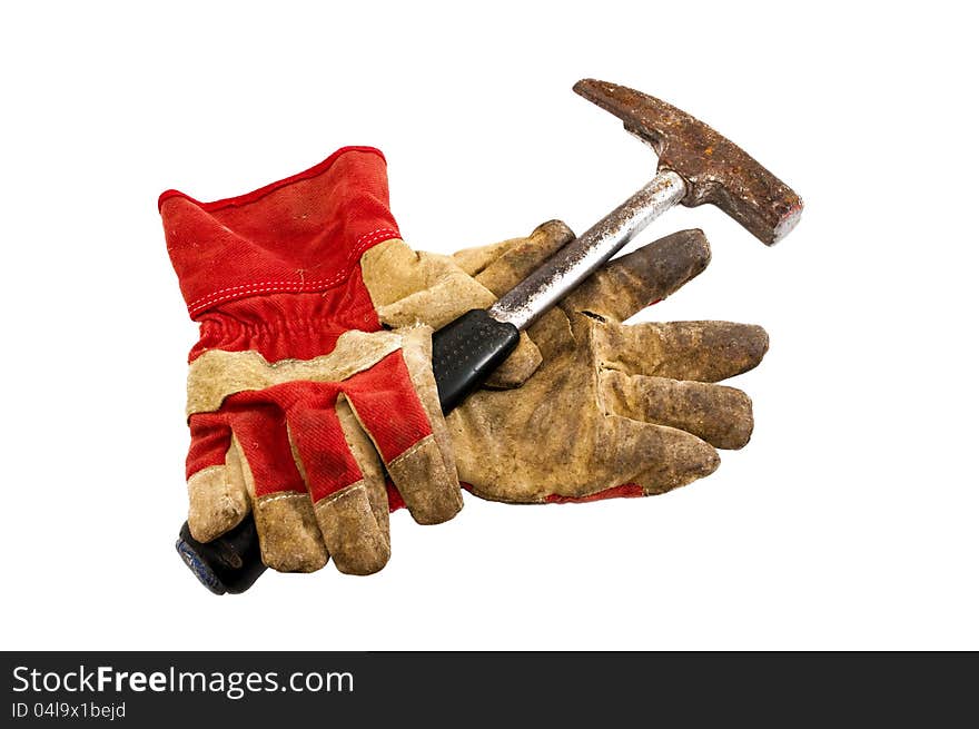 Old work gloves and a hammer on a white background