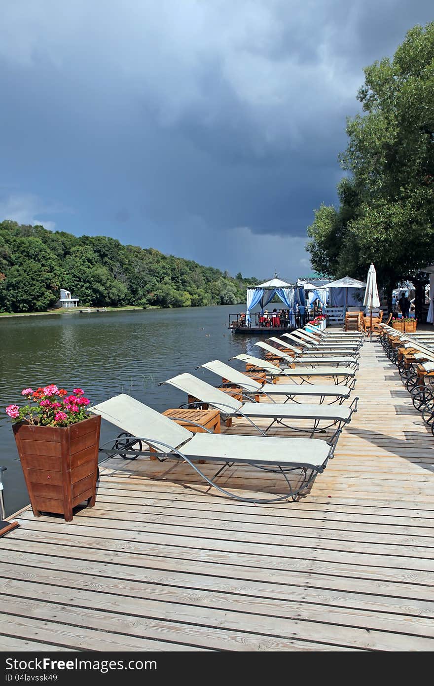 Lounge Chairs On A Wooden Pier