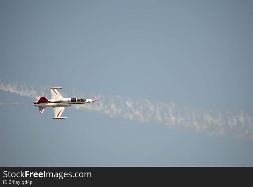 A plane demonstrating its acrobatics at an Air Show. A plane demonstrating its acrobatics at an Air Show