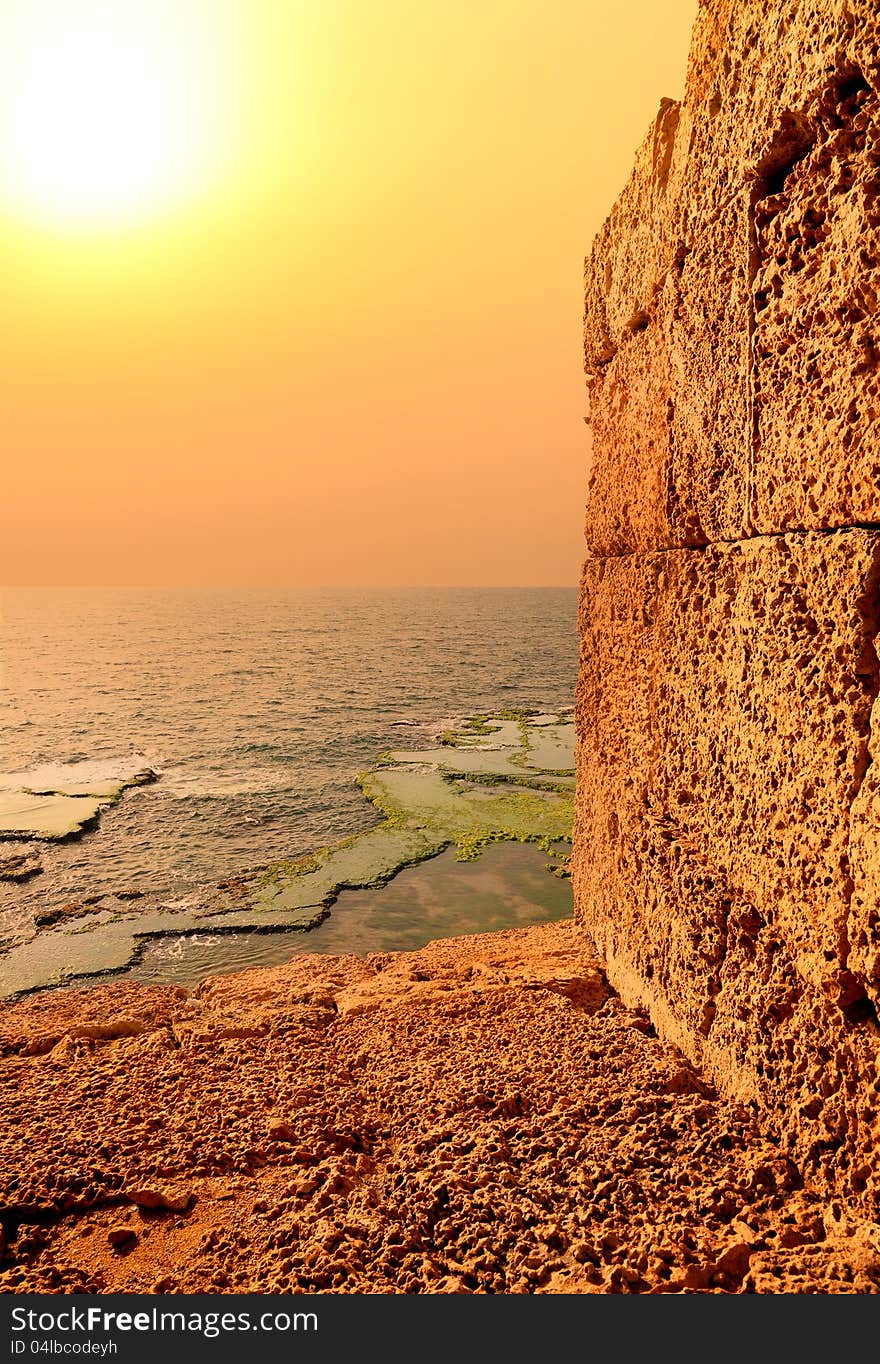 Mediterranean Orange Sunset through an ancient wall made from Jerusalem stone