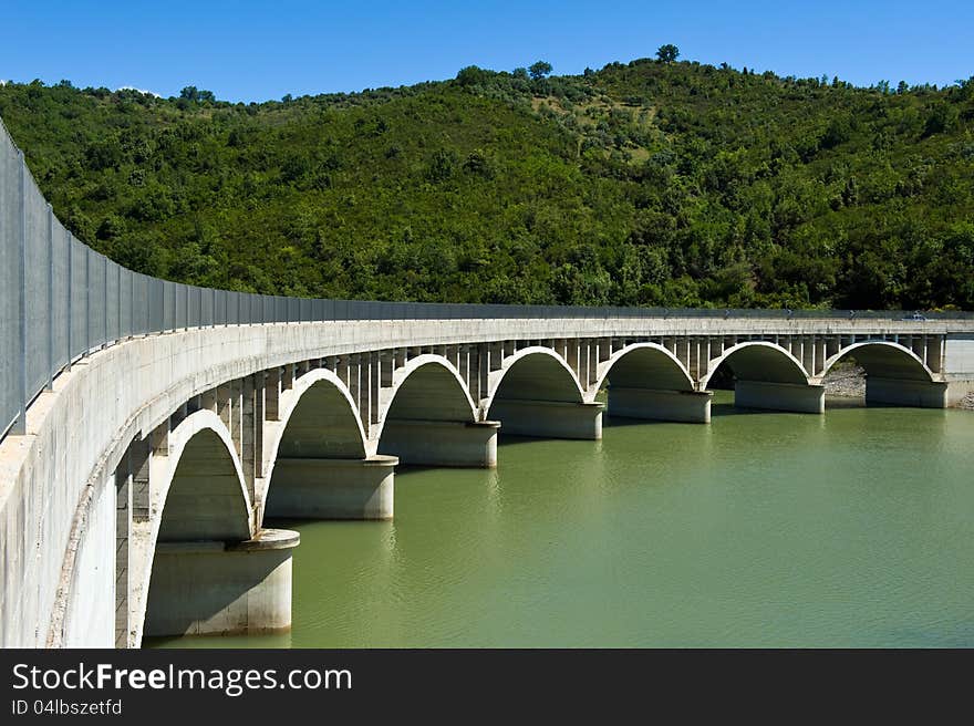 Arched bridge over the dam Alento