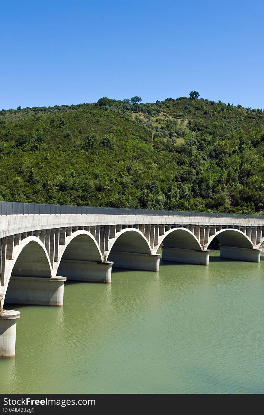 Arched bridge over the dam Alento