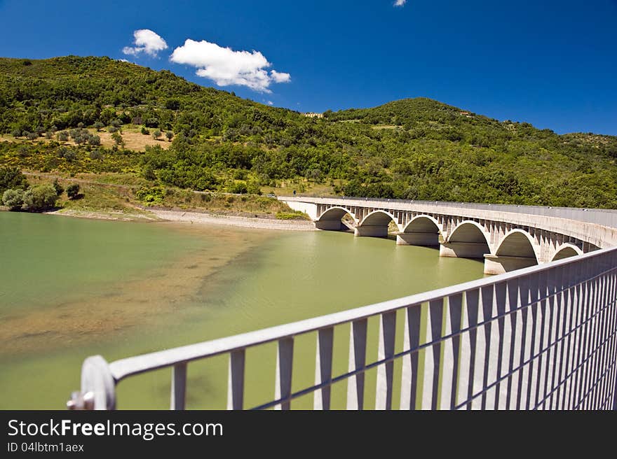 Arched bridge over the dam Alento