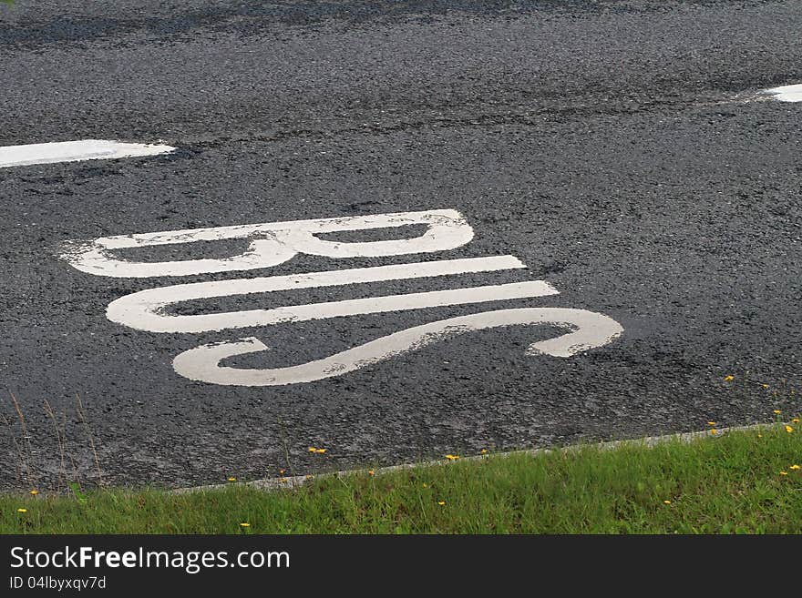 Bus lane text on asphalt road.