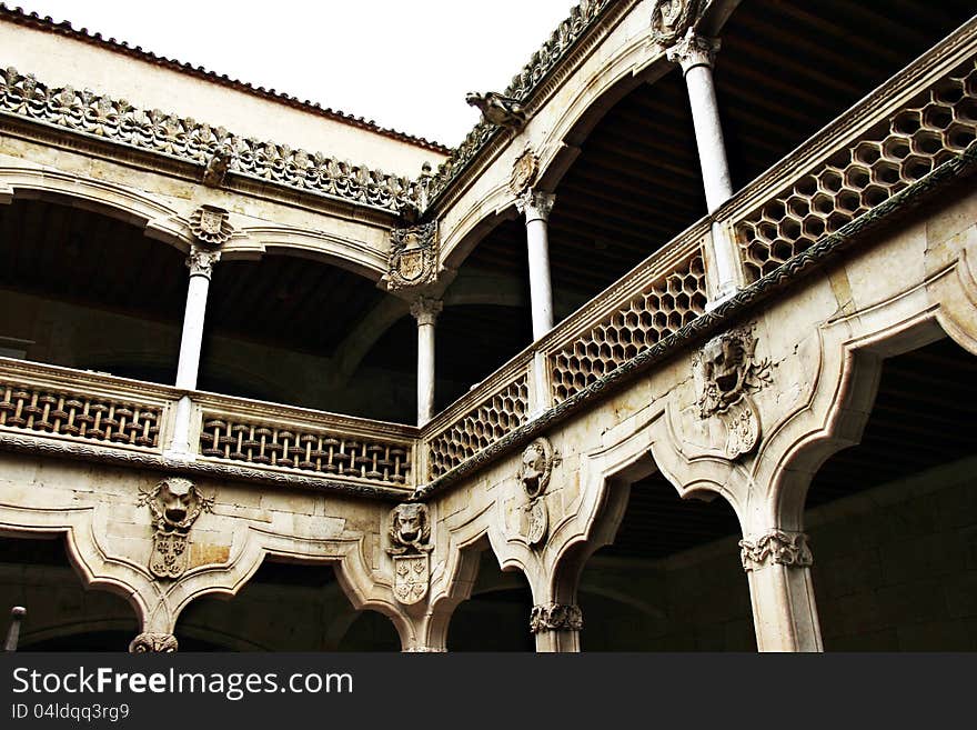 The interior of a courtyard built out of white sandstone with evident gothic symbolism- gargoyles, and floral decorations and stylized arches. The interior of a courtyard built out of white sandstone with evident gothic symbolism- gargoyles, and floral decorations and stylized arches.