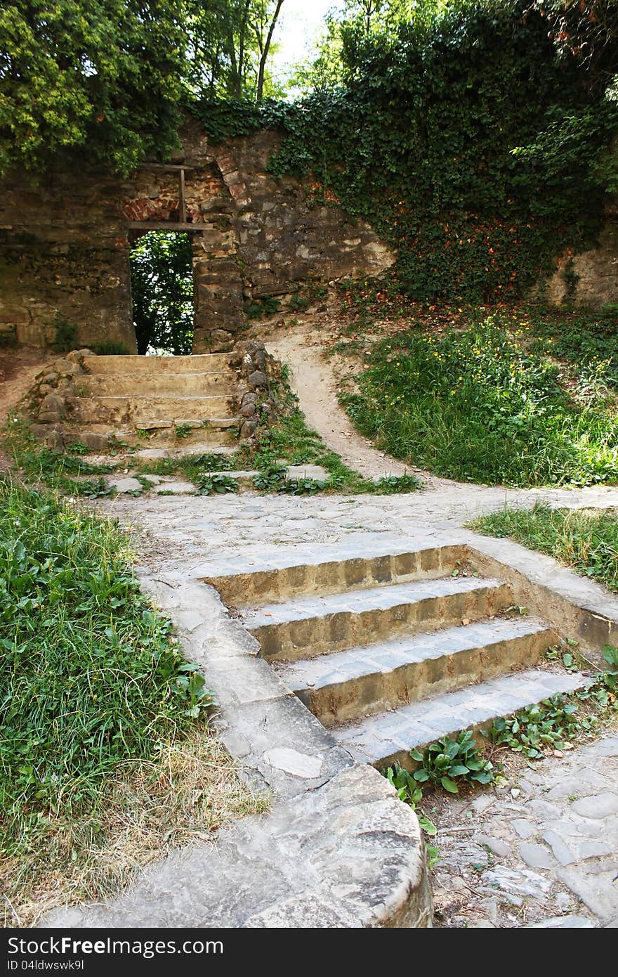 Mysterious wall opening and brick steps in Sighisoara curchyard, Transylvania, Romania.