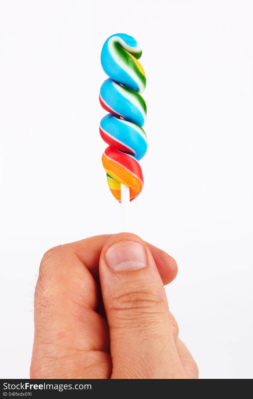 Lollipop candy in hand  on white