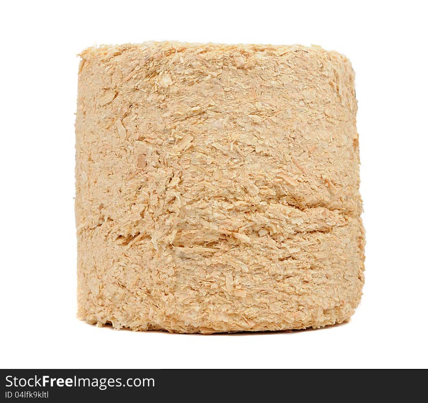 A compressed sawdust fire log on a white background