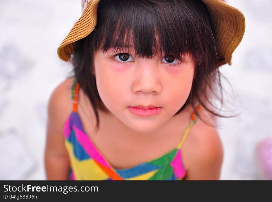 Girl in hat stares up