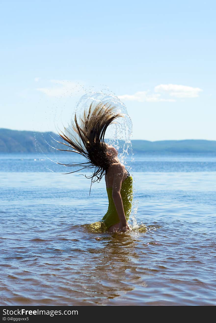 Child in the water waving hair. Child in the water waving hair