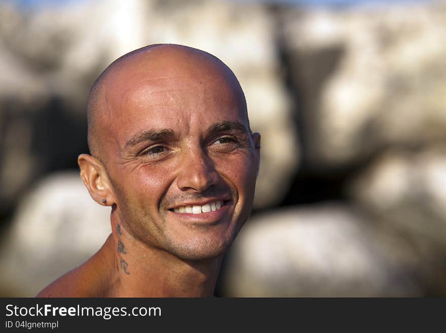 Very muscular young tourist at the beach with great care for his body. Very muscular young tourist at the beach with great care for his body