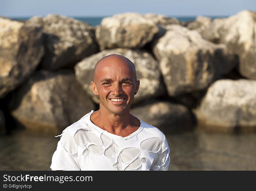 Very muscular young tourist at the beach with great care for his body. Very muscular young tourist at the beach with great care for his body