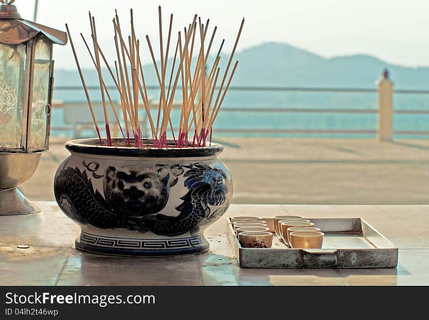 Aroma sticks in Thailand's temple with the mountains in a background. Aroma sticks in Thailand's temple with the mountains in a background