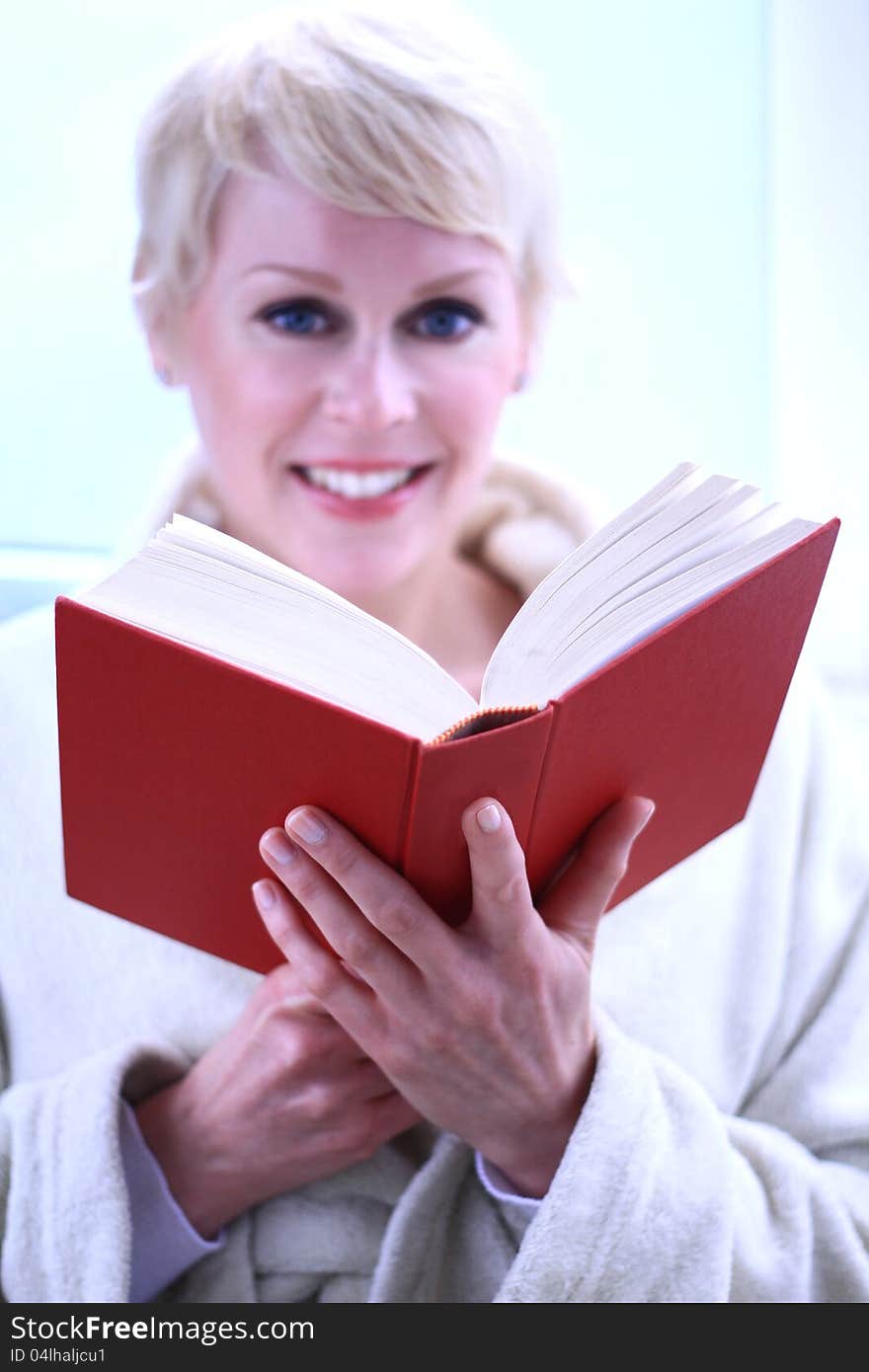 Image of a woman reading a book the library