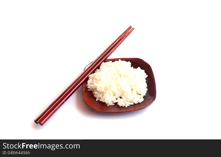 Rice on dish and chopsticks on a white background.