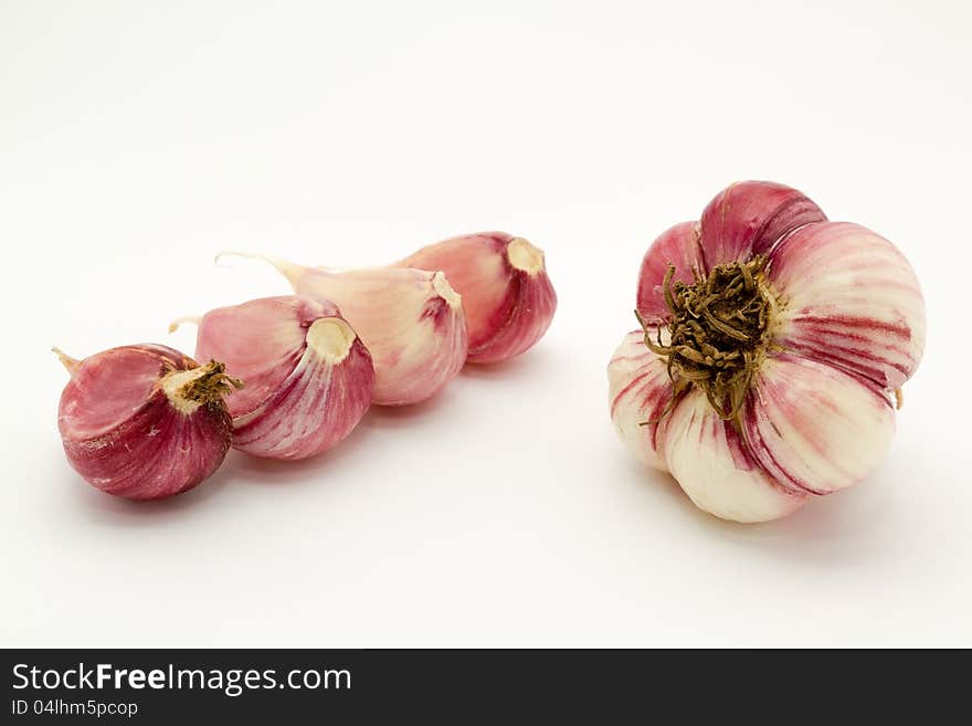 Winter garlic cloves, isolated on white.