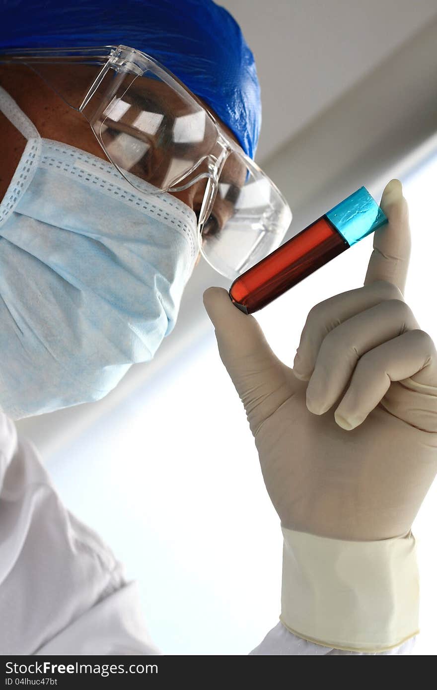 Image of a scientist testing a chemical fluid in the lab. Image of a scientist testing a chemical fluid in the lab