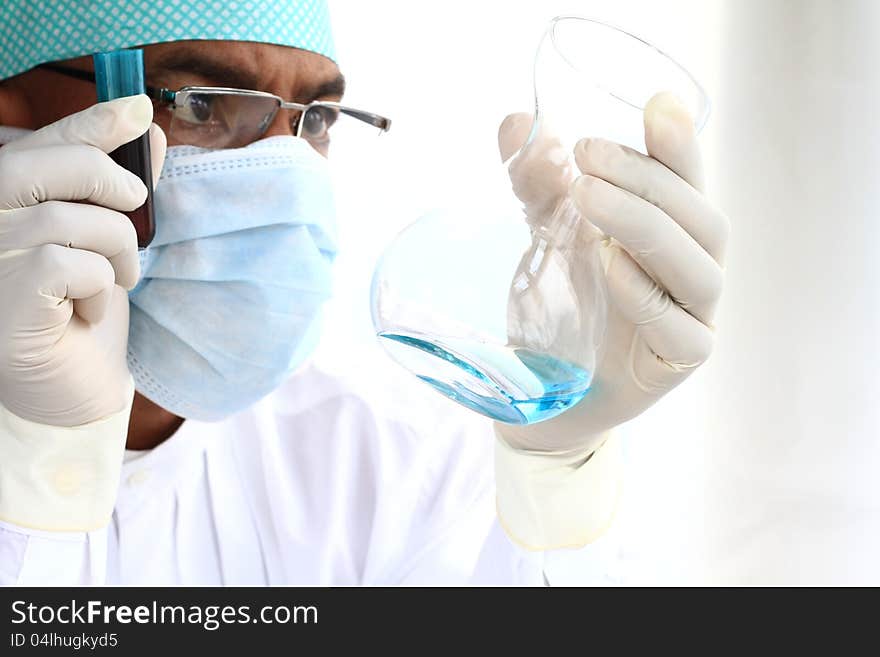 Image of a scientist testing a chemical fluid in the lab. Image of a scientist testing a chemical fluid in the lab