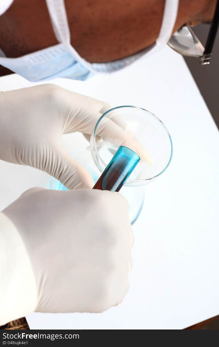 Image of a scientist testing a chemical fluid in the lab. Image of a scientist testing a chemical fluid in the lab