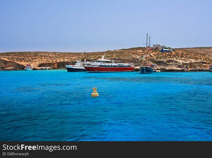 Phenomenal sea water near Comino Island in Malta with cruise ships. Phenomenal sea water near Comino Island in Malta with cruise ships.