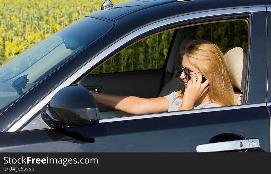 Woman driver talking on her mobile