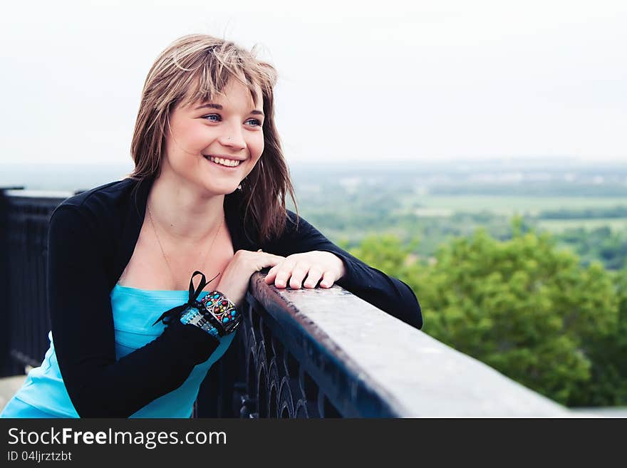 Smiling girl, she looks into distance