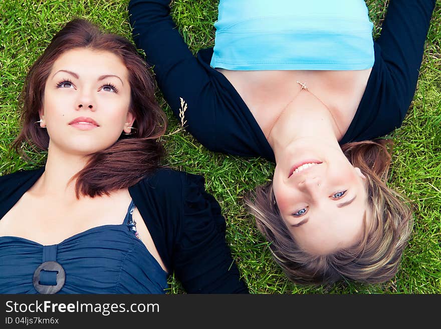 Two Girls Lying On Grass